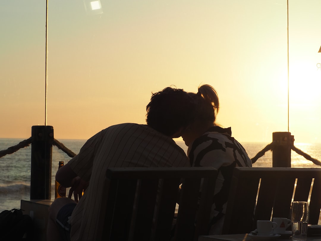family eating dinner at a casual beachfront restaurant at sunset