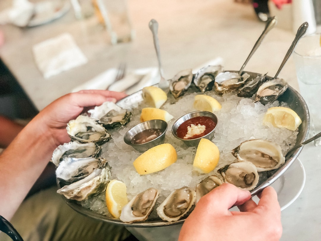 fresh oysters on a tray with lemon and cocktail sauce