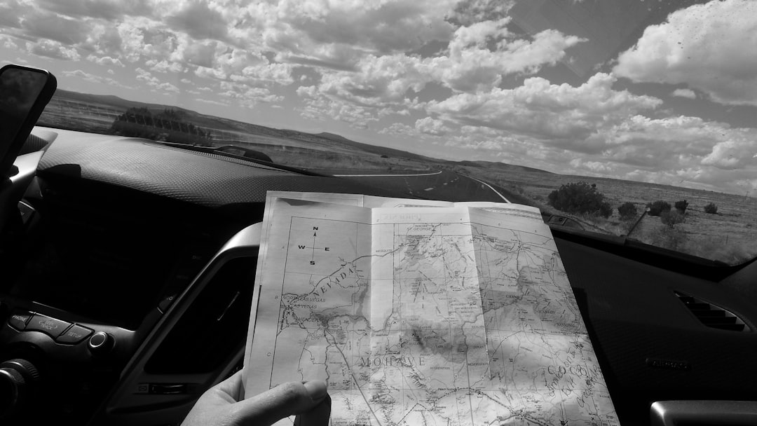 group of friends looking at a map and planning a road trip