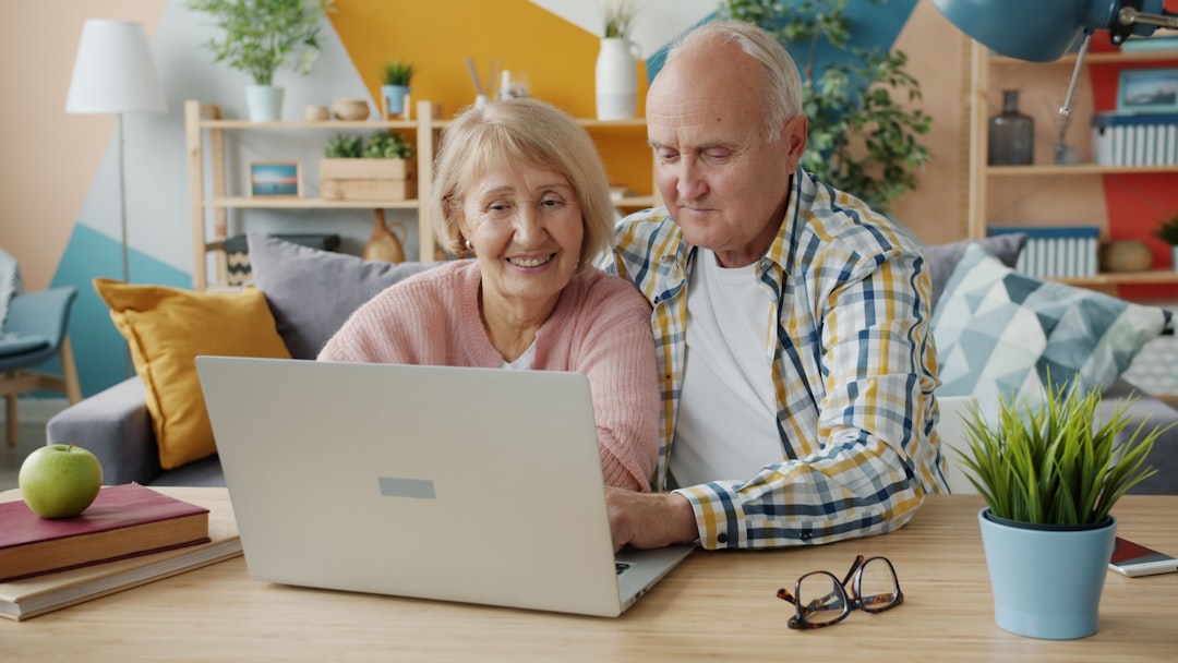 happy couple planning a vacation on a laptop at home